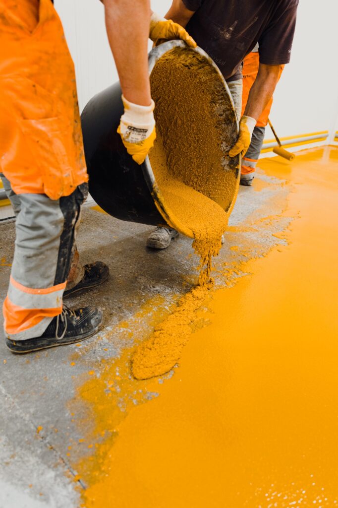 epoxy flooring applicator performs painting works with polyurethane epoxy mortar